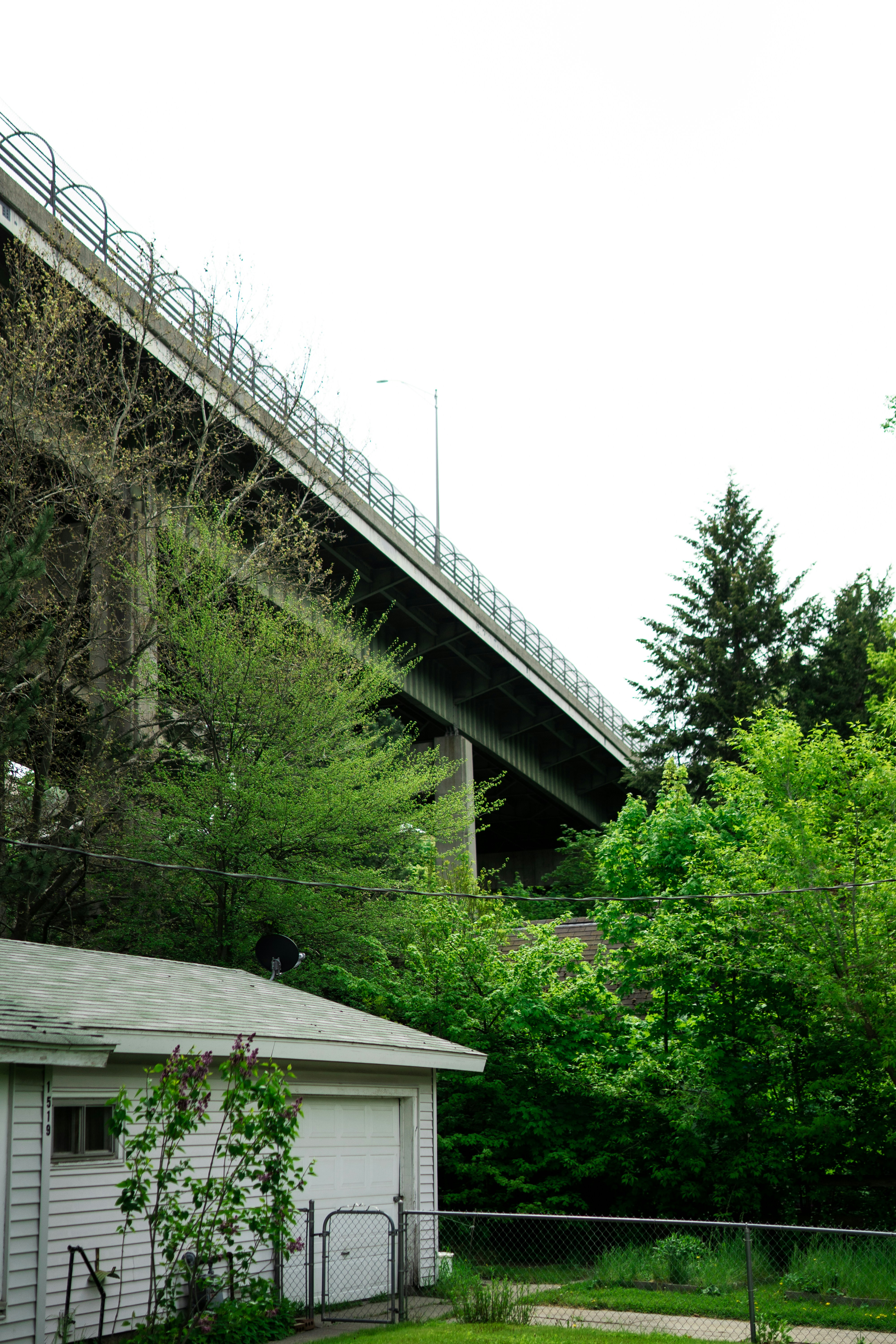 a white house with a bridge in the background