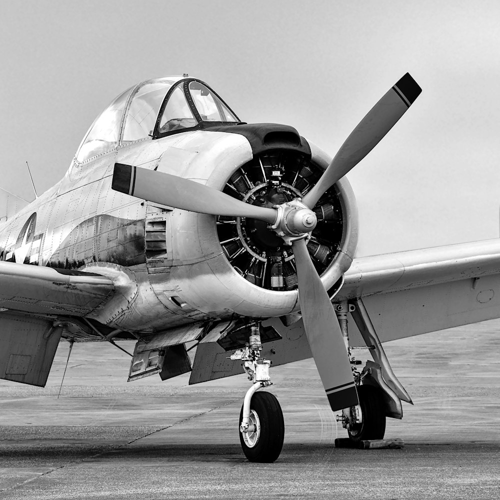 a propeller plane sitting on top of an airport tarmac