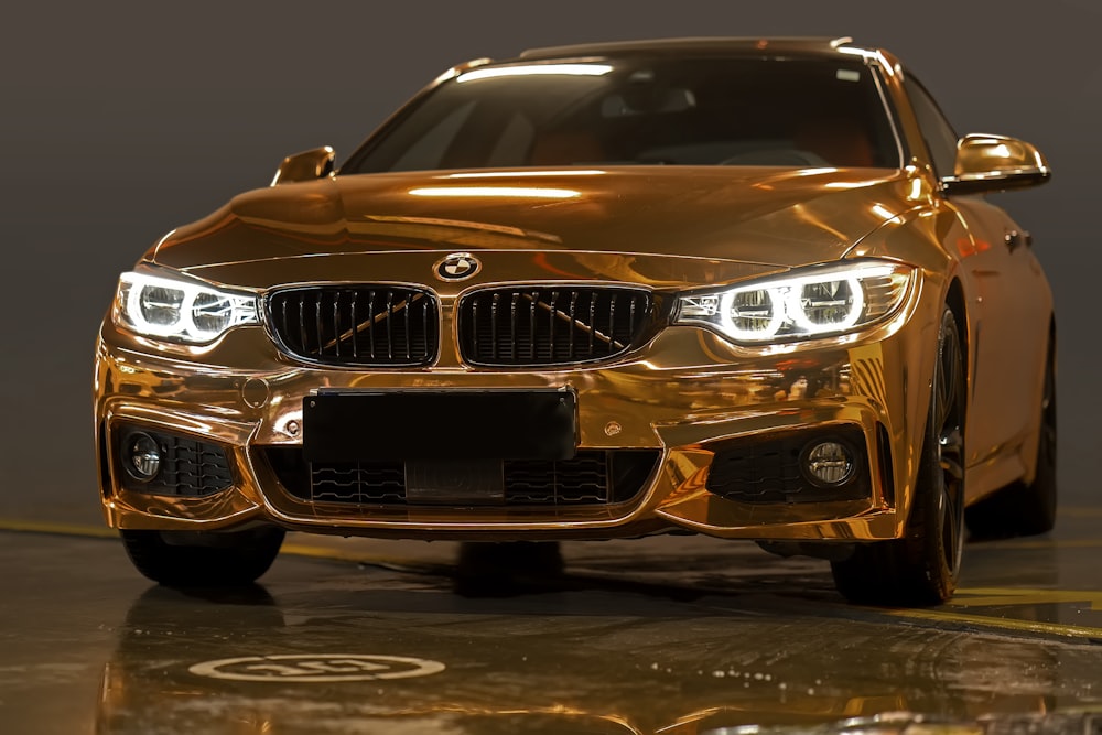 a shiny gold car parked in a garage