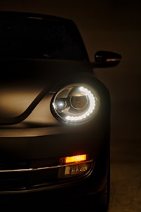 a close up of a car's headlight in the dark