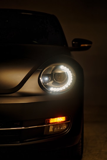 a close up of a car's headlight in the dark