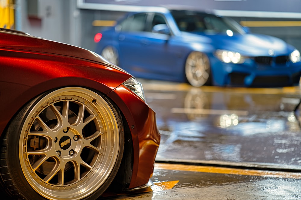 a red car parked next to a blue car