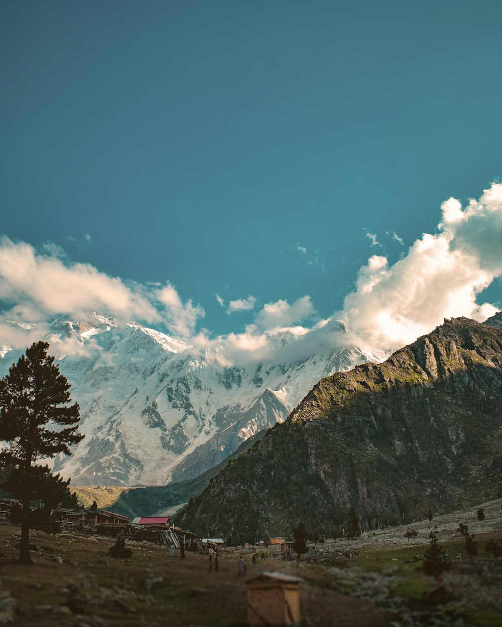 a view of a mountain range with clouds in the sky