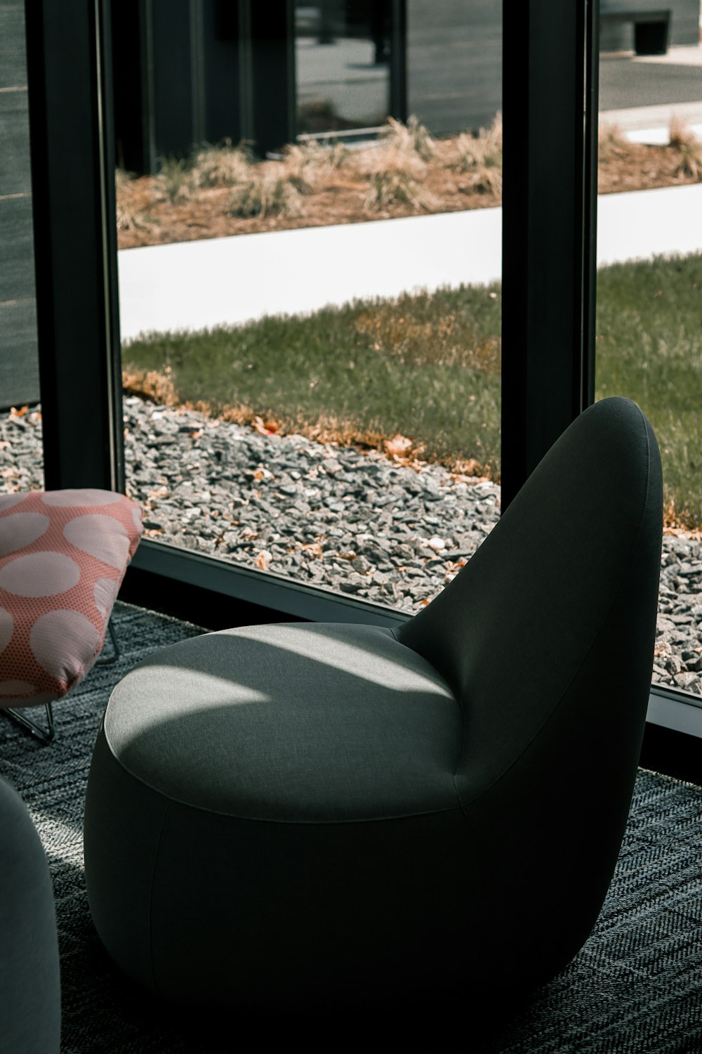 a chair and ottoman in front of a window