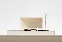 a model of a building with a palm tree in front of it