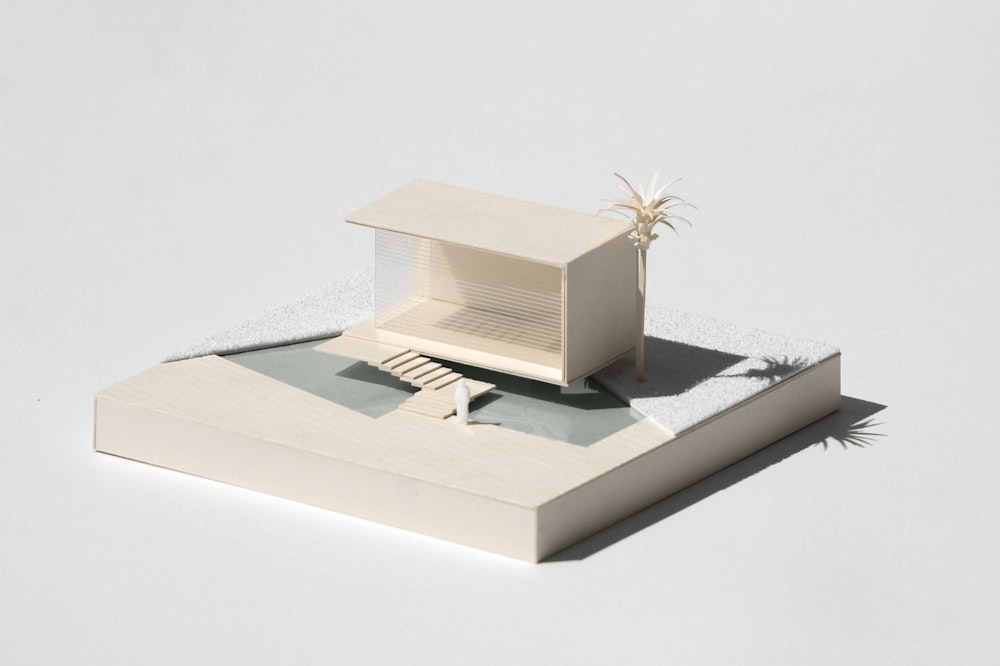 a model of a house sitting on top of a book