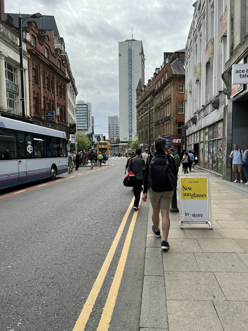 a group of people walking on a city street