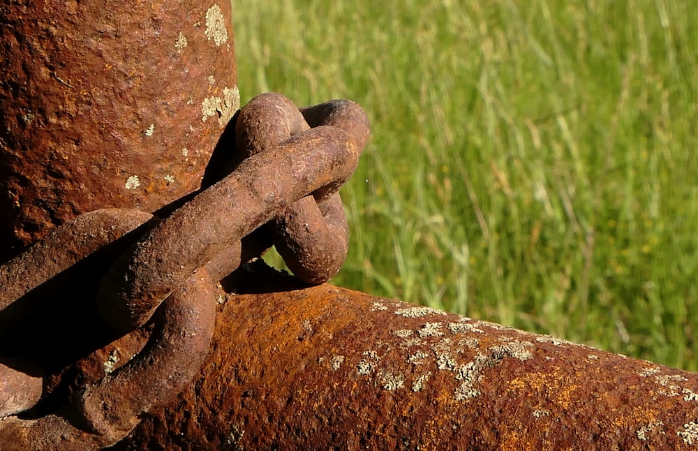 a rusted chain is attached to a rusty pole