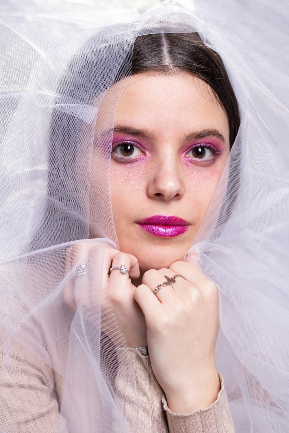 a woman in a veil with a ring on her finger