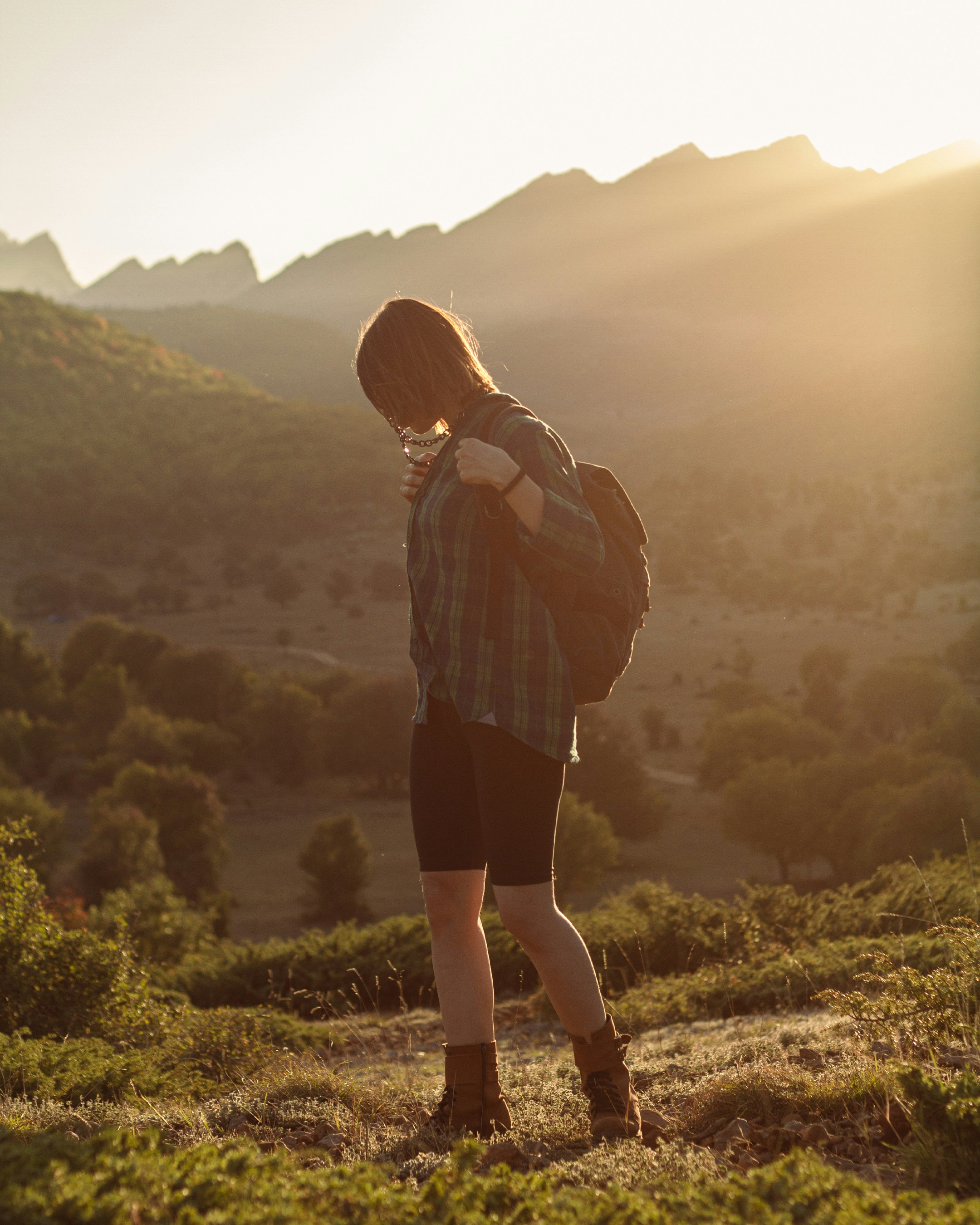 a person standing in a field with a backpack