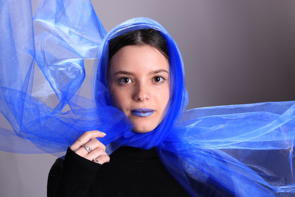 a woman with a blue scarf around her head