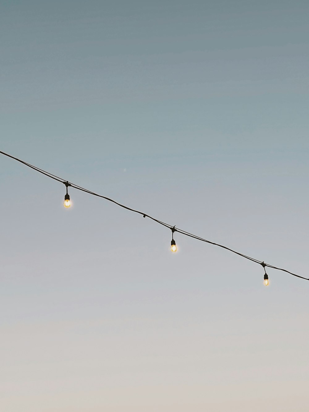 a long line of light bulbs hanging from a wire