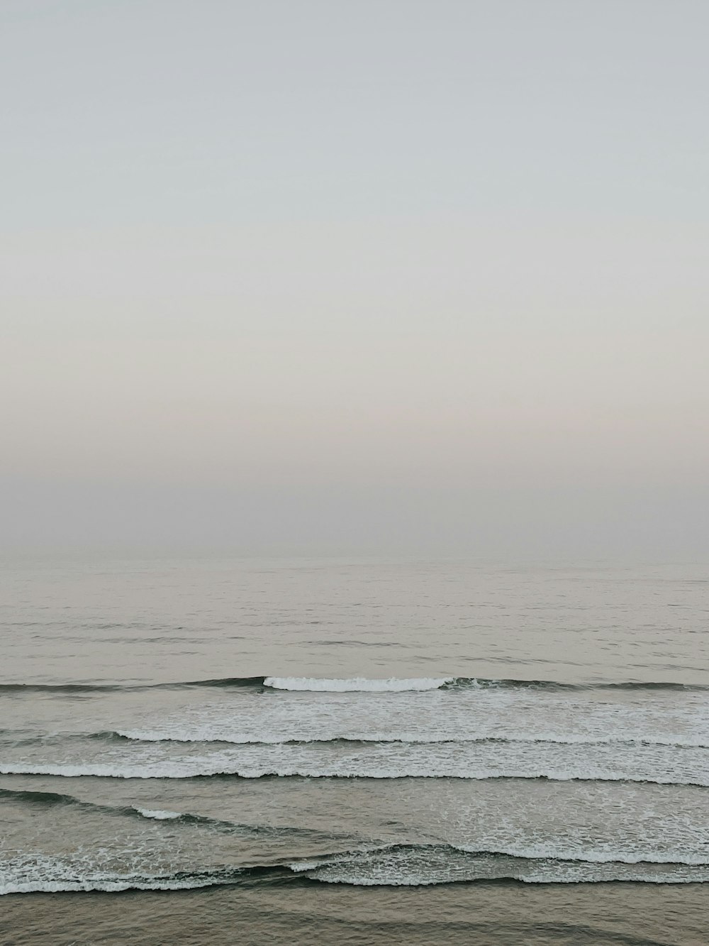 a person riding a surfboard on top of a wave