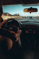 a person driving a car on a highway