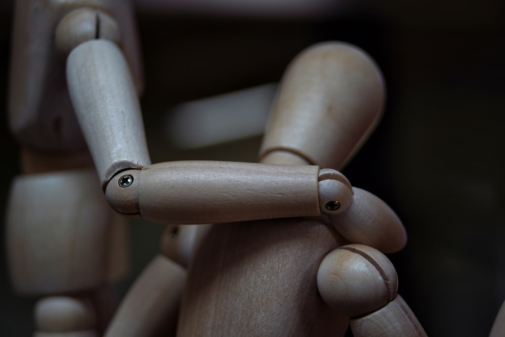 a close up of a wooden toy with eyes