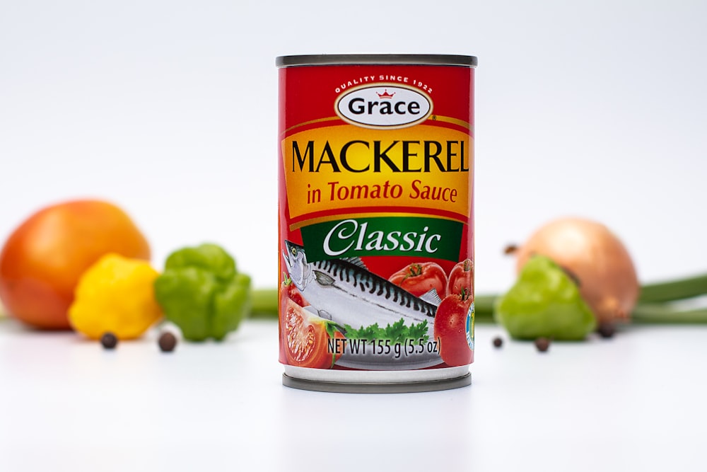 a can of mackere in tomato sauce next to some vegetables