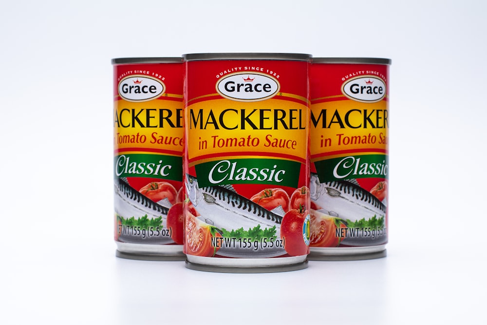 three cans of tomato sauce on a white background