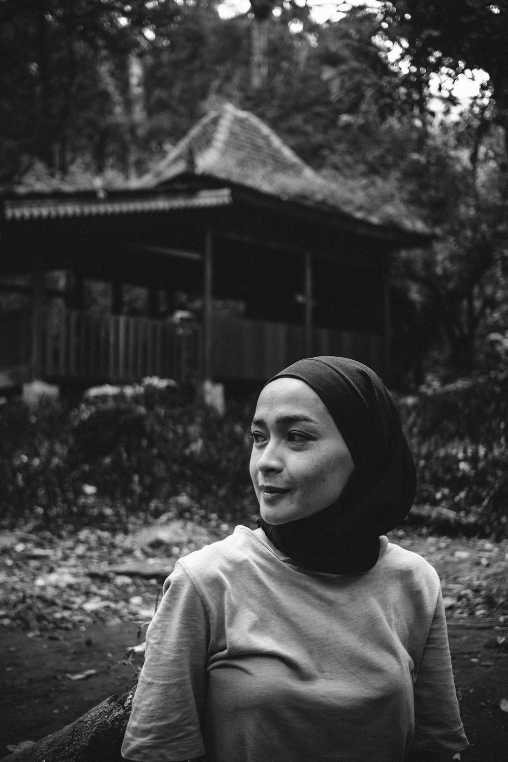 a woman wearing a hijab standing in front of a building