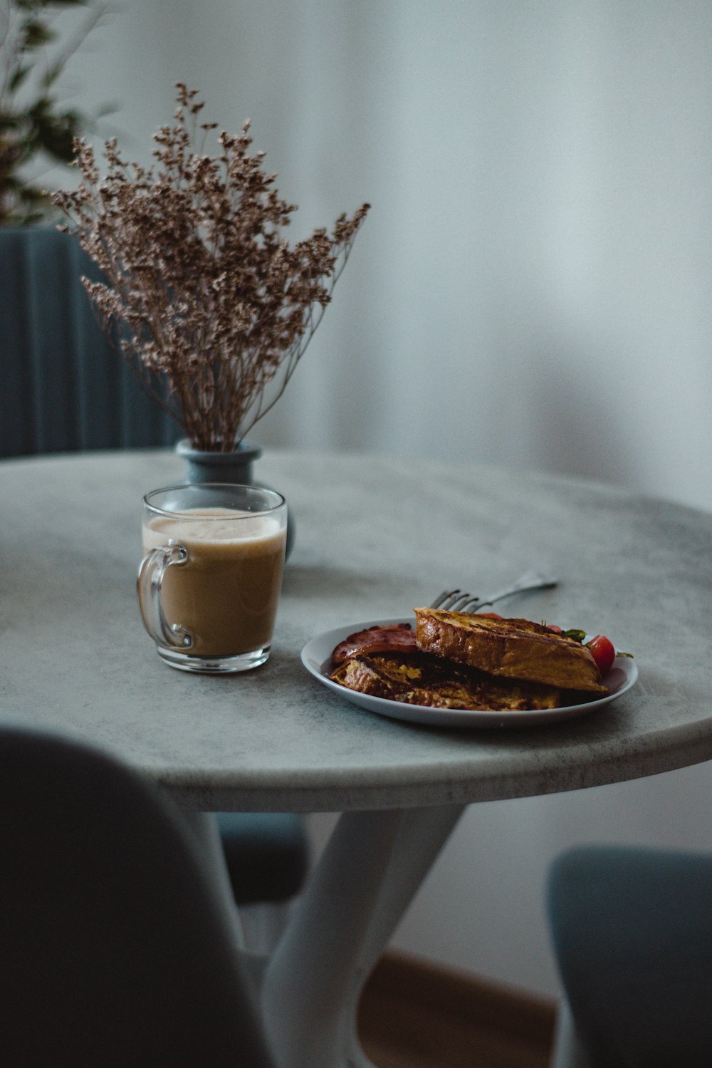 a plate of food and a cup of coffee on a table