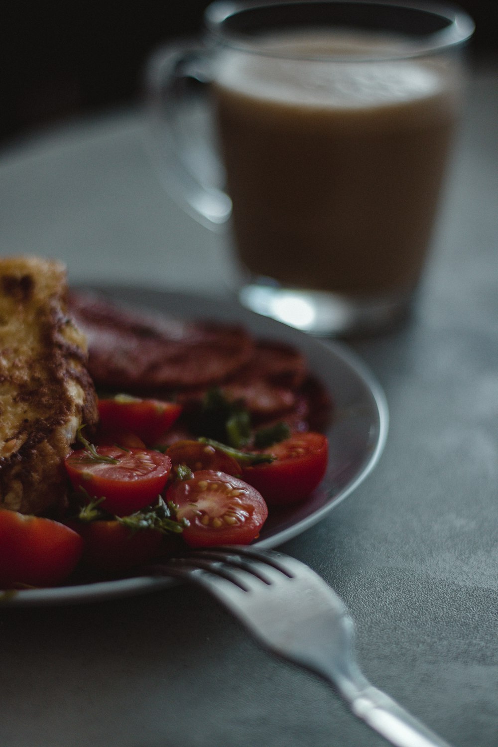 a plate of food and a glass of coffee