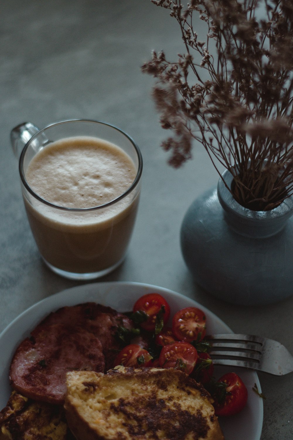 a plate of food and a cup of coffee on a table