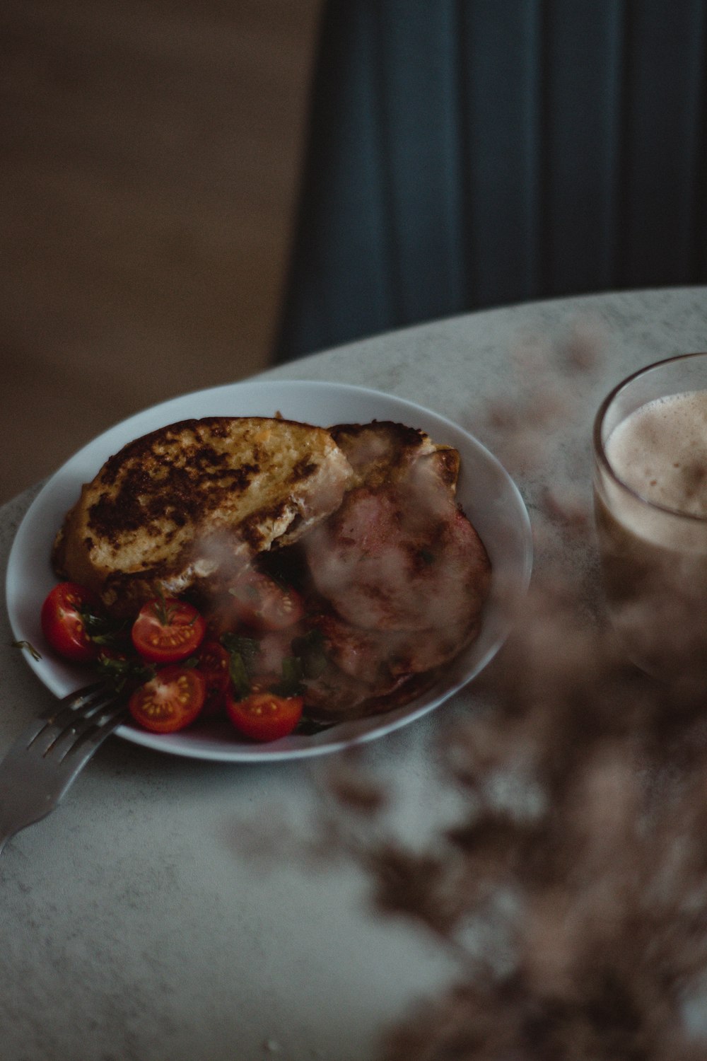 a plate of food and a glass of milk on a table