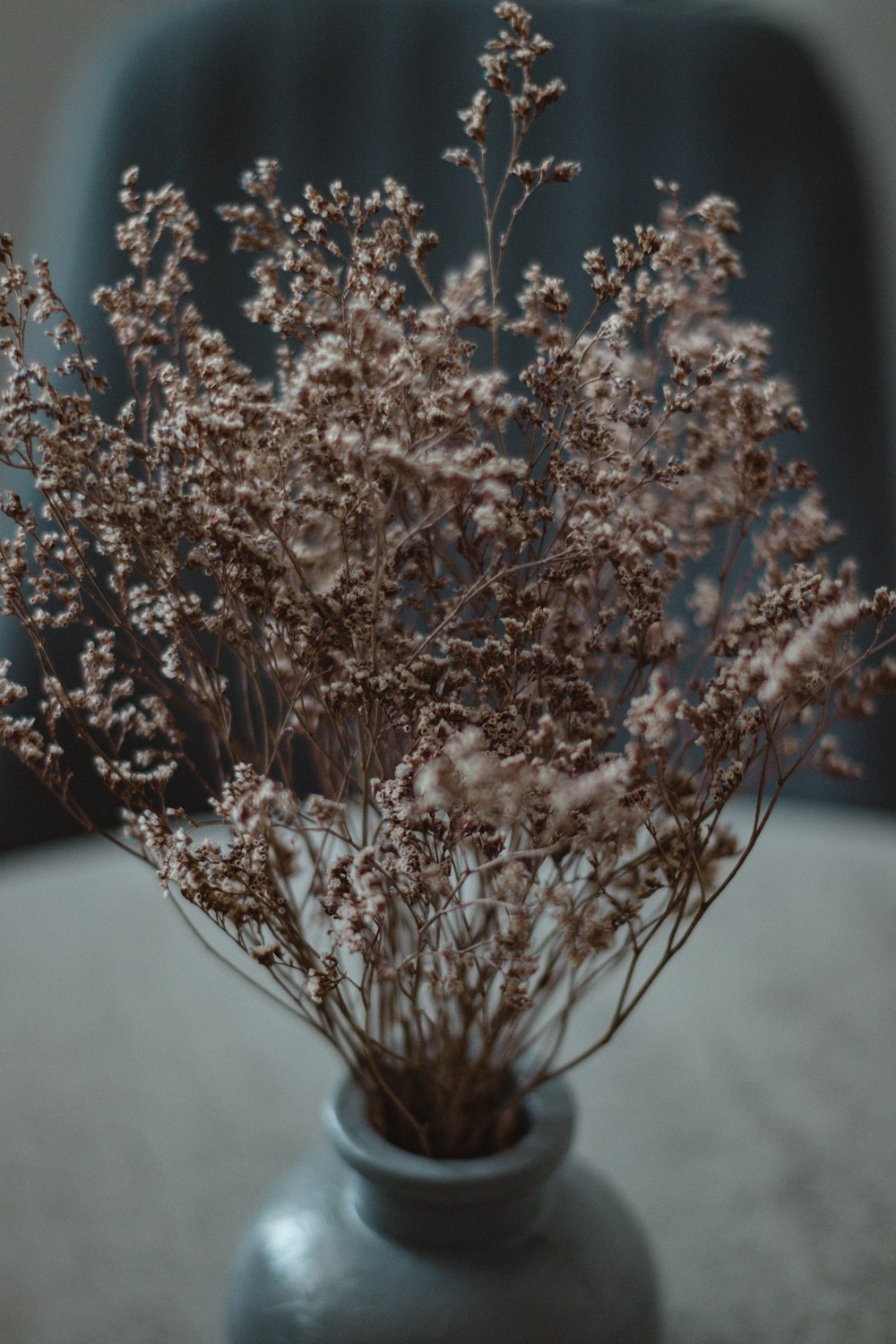 a vase filled with flowers sitting on top of a table