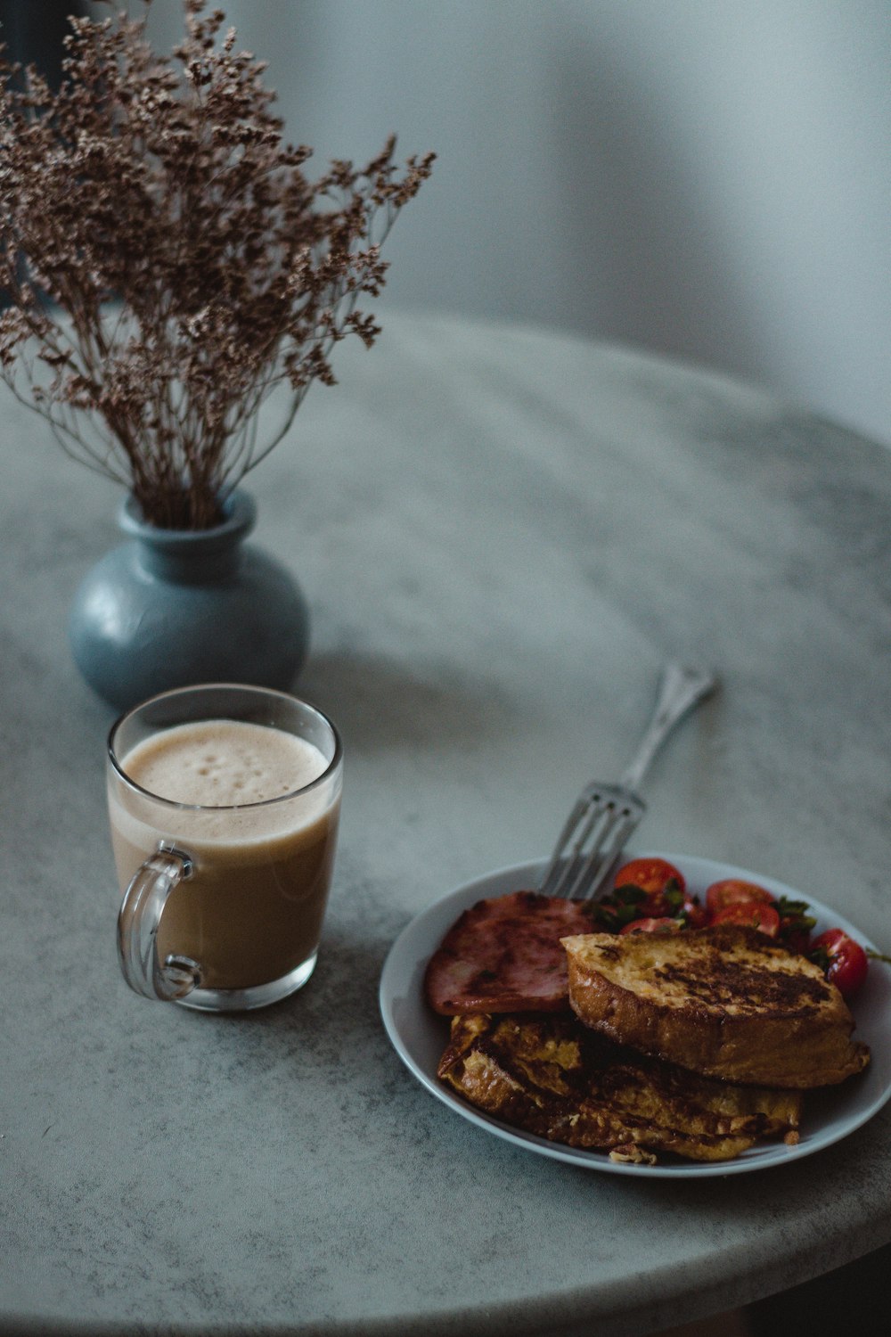 a plate of food and a cup of coffee on a table