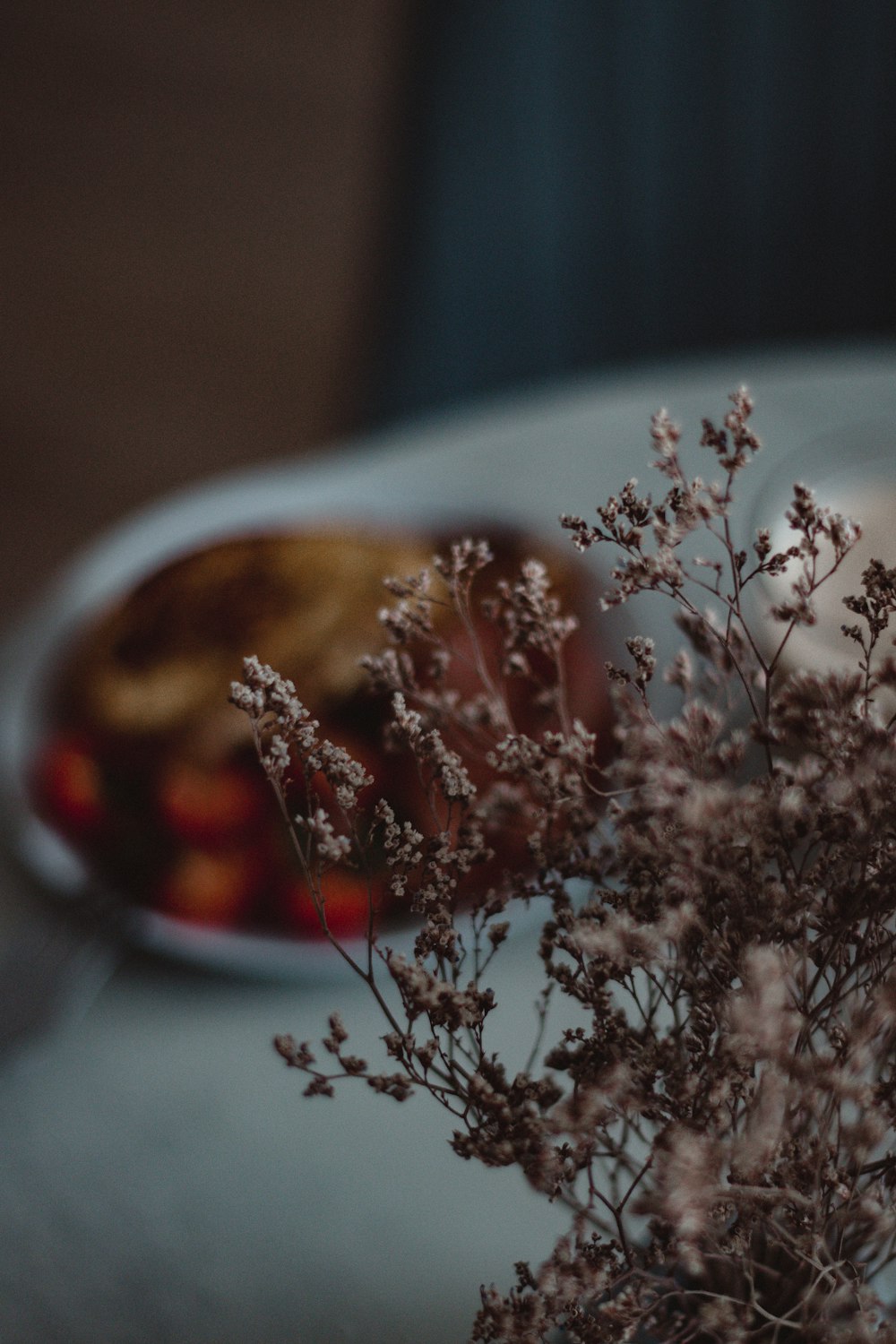 a vase filled with flowers sitting on top of a table