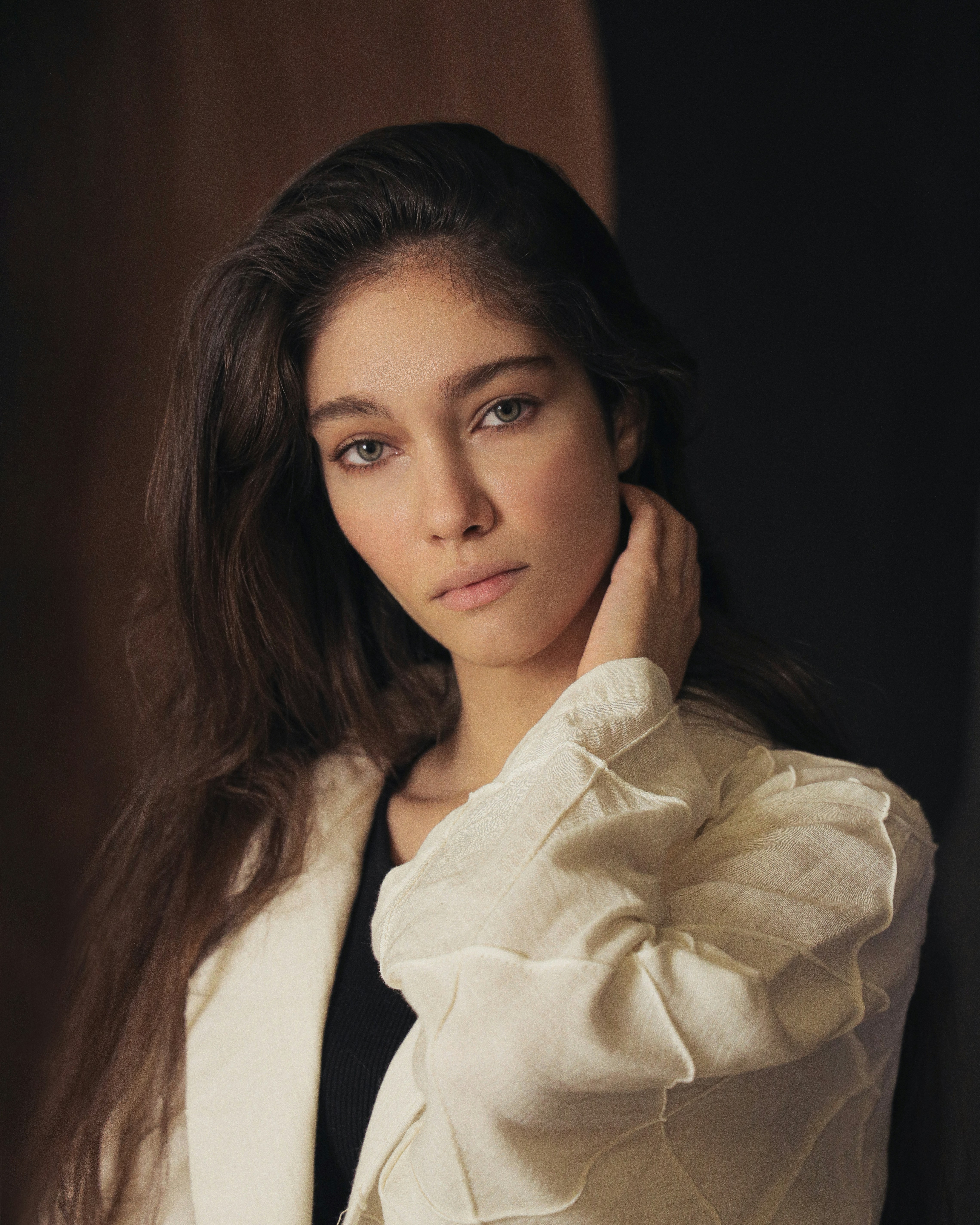 a woman posing for a picture in a white jacket