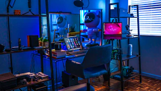 a room with a desk, chair, and computer monitor