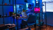 A futuristic workspace bathed in cosmic neon blue hues with tech gadgets on display.