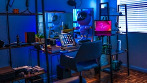 A futuristic workspace bathed in cosmic neon blue hues with tech gadgets on display.
