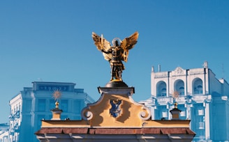 a statue of an angel on top of a building