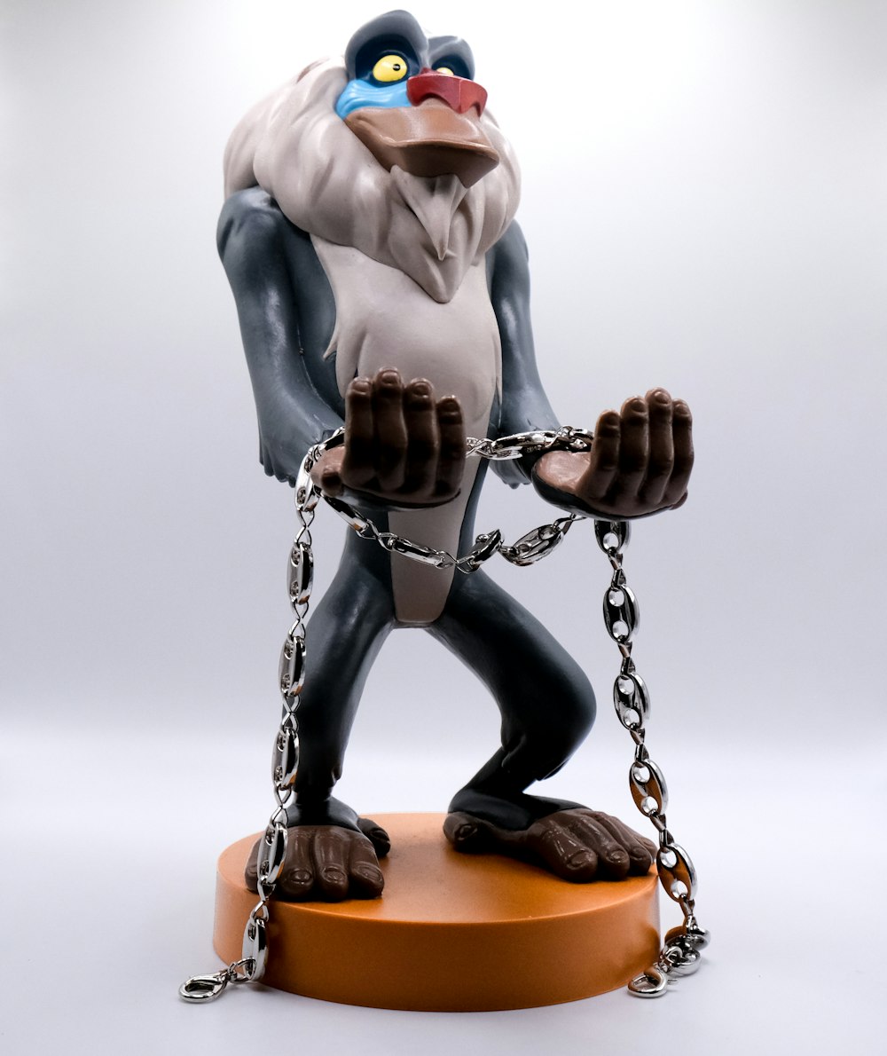 a figurine of a monkey chained to a chain