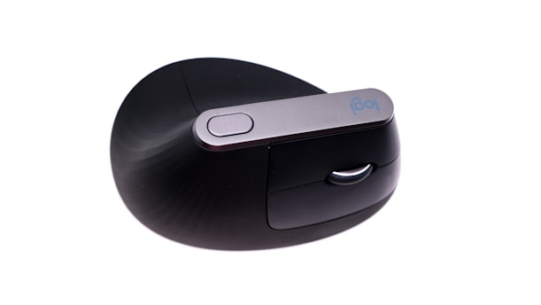 a close up of a mouse on a white surface