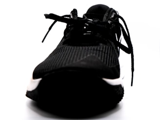A close-up of a running shoe on a track, showcasing its design and texture.