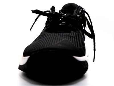 A close-up of a running shoe on a track, showcasing its design and texture.