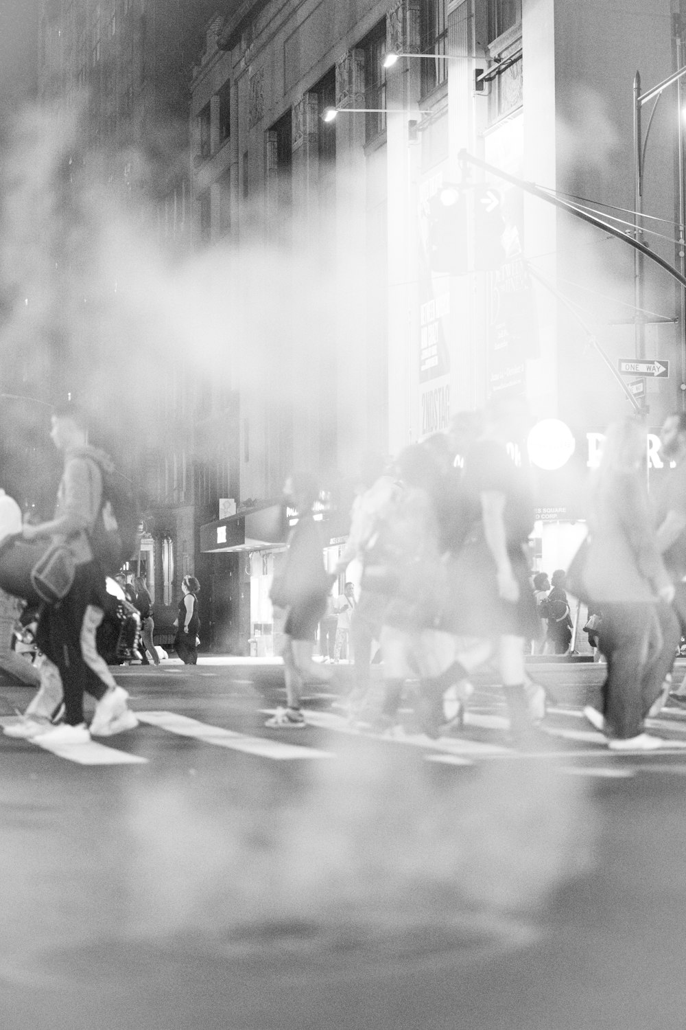 a group of people walking across a street