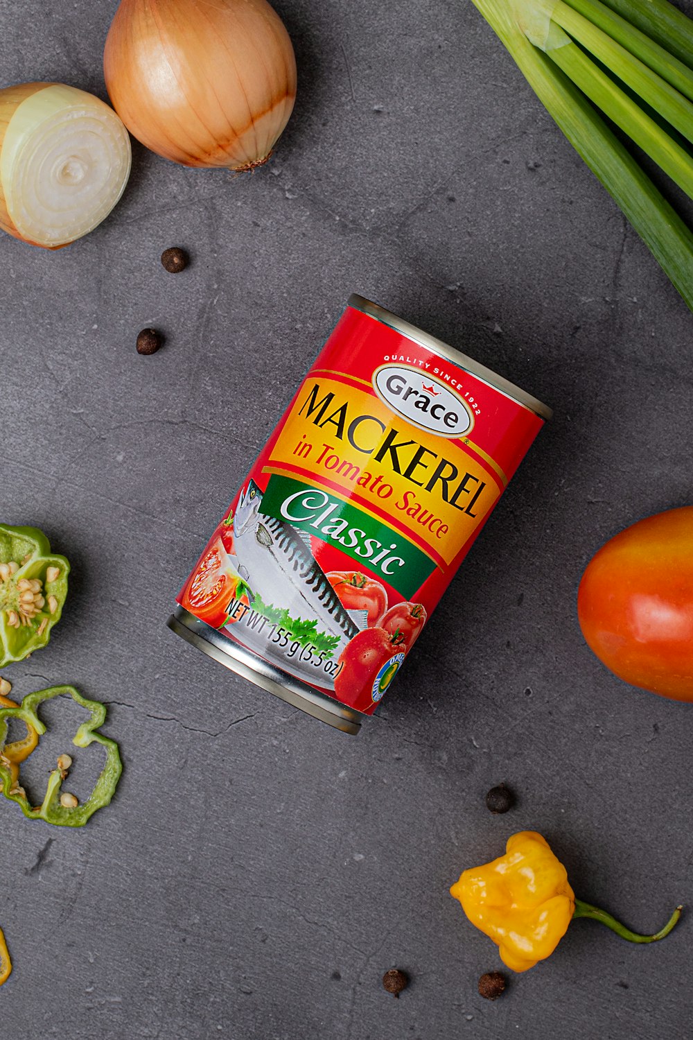 a can of canned food next to some vegetables