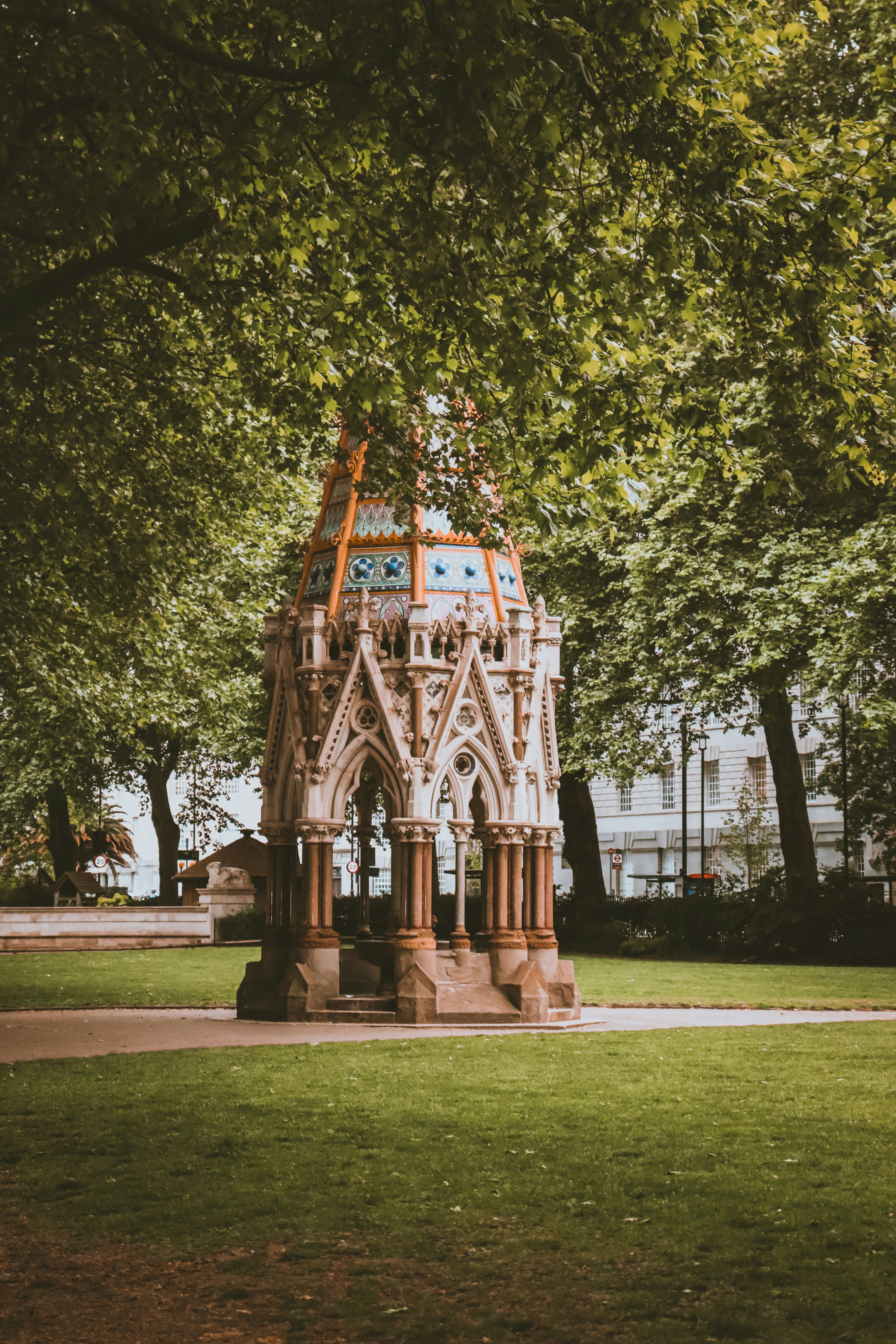 a clock tower in the middle of a park