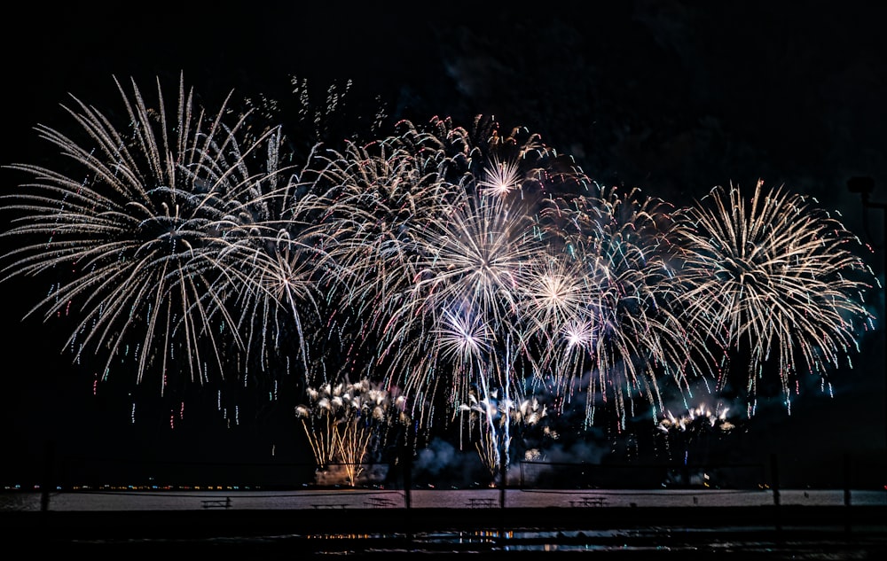 a bunch of fireworks are lit up in the night sky