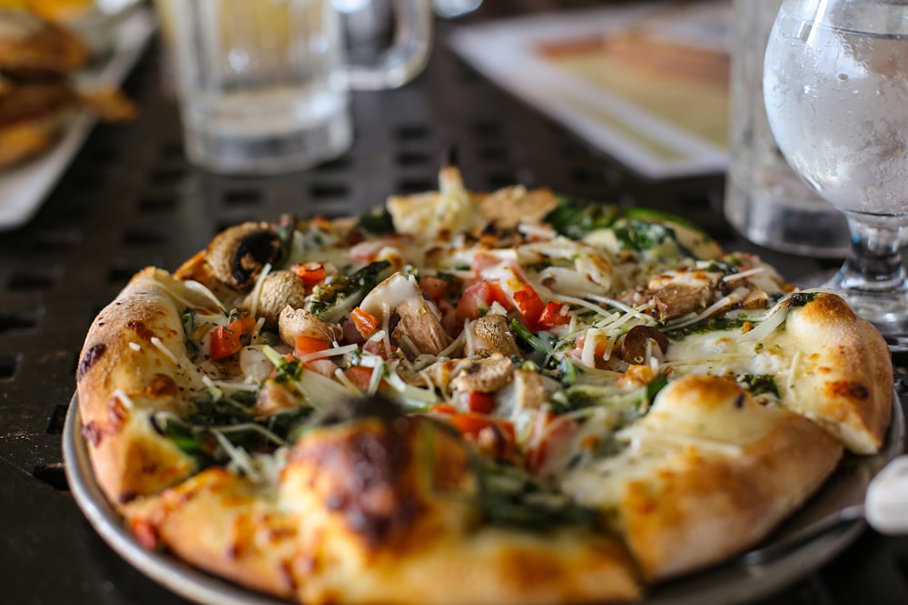 a pizza sitting on top of a pan on a table