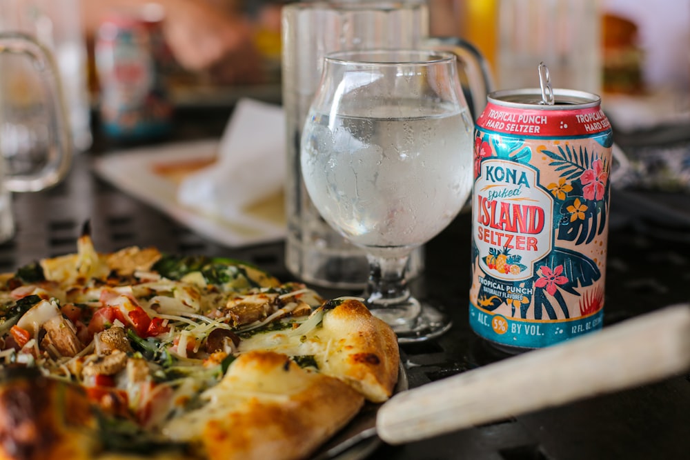 a pizza sitting on top of a table next to a glass of water