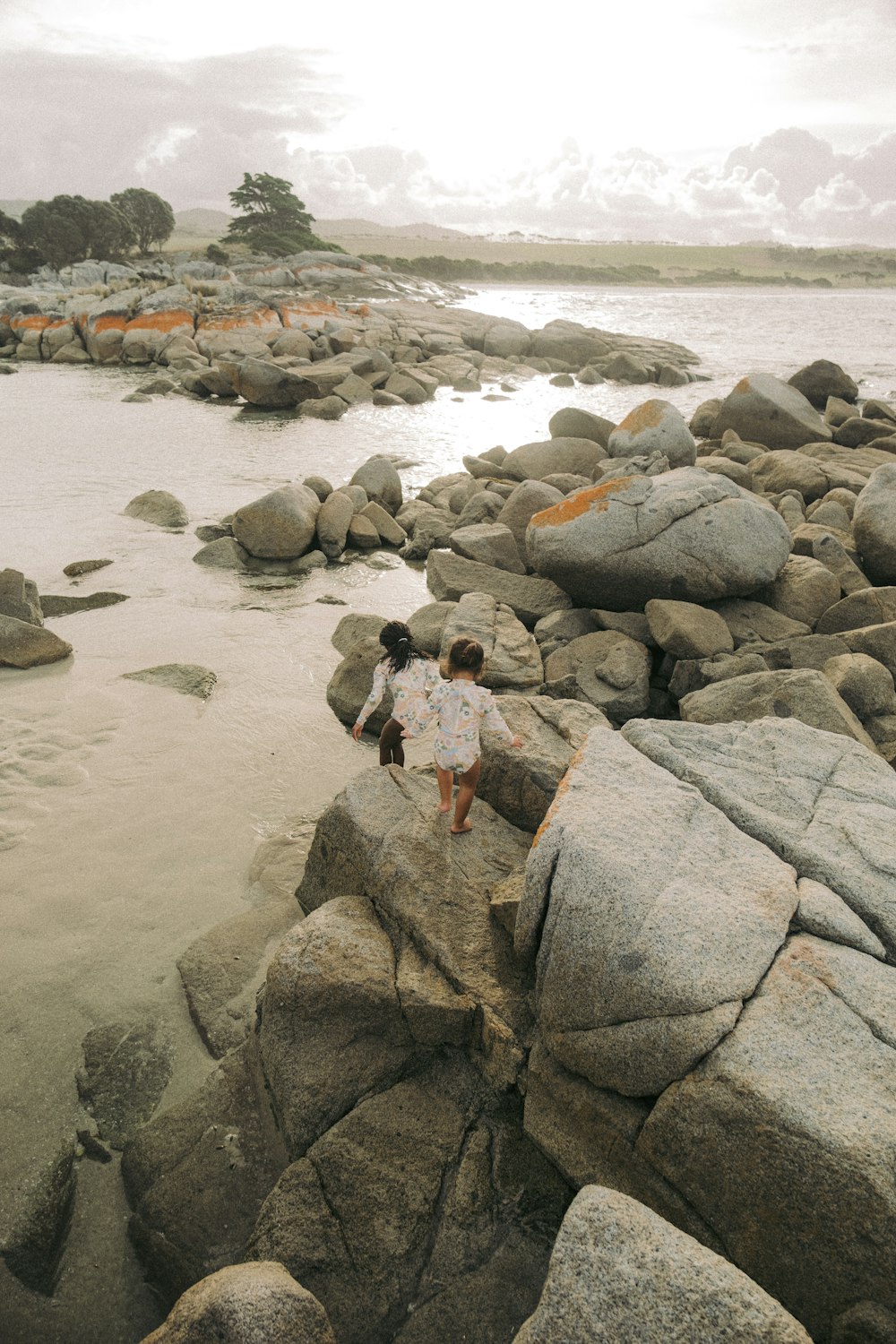 a couple of people that are standing on some rocks