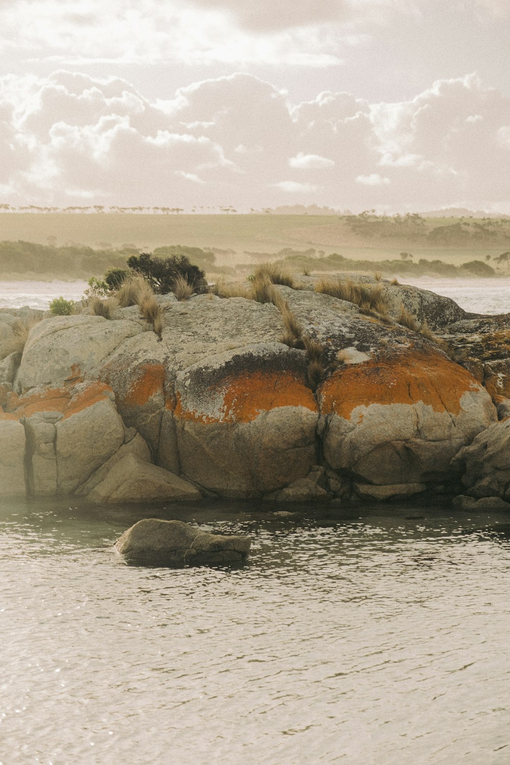 a rock outcropping in the middle of a body of water