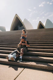 a man and a woman sitting on the steps of a building