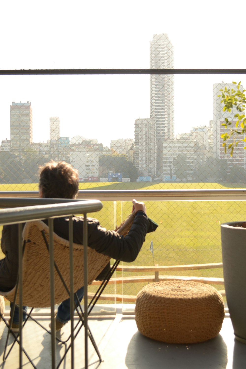 a person sitting in a chair on a balcony