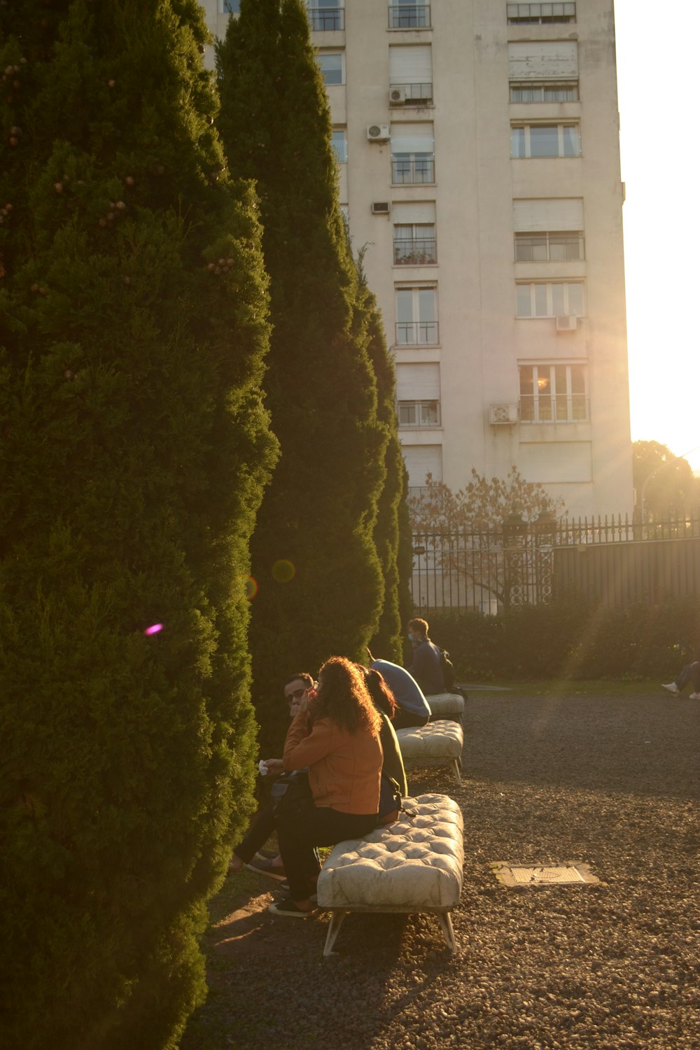 a woman sitting on a bench in a park