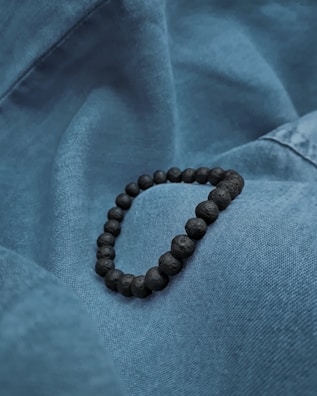 A stylish bracelet resting on a textured fabric.